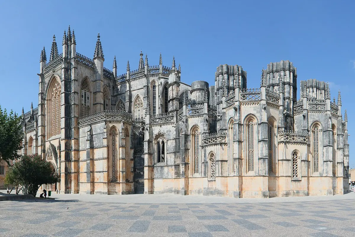 The east end of Batalha Monastery seen from the square, with the Gothic church on the left and the roofless towers of the Unfinished Chapels on the right